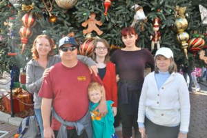 Our family posing in front of the Christmas tree at Main Street